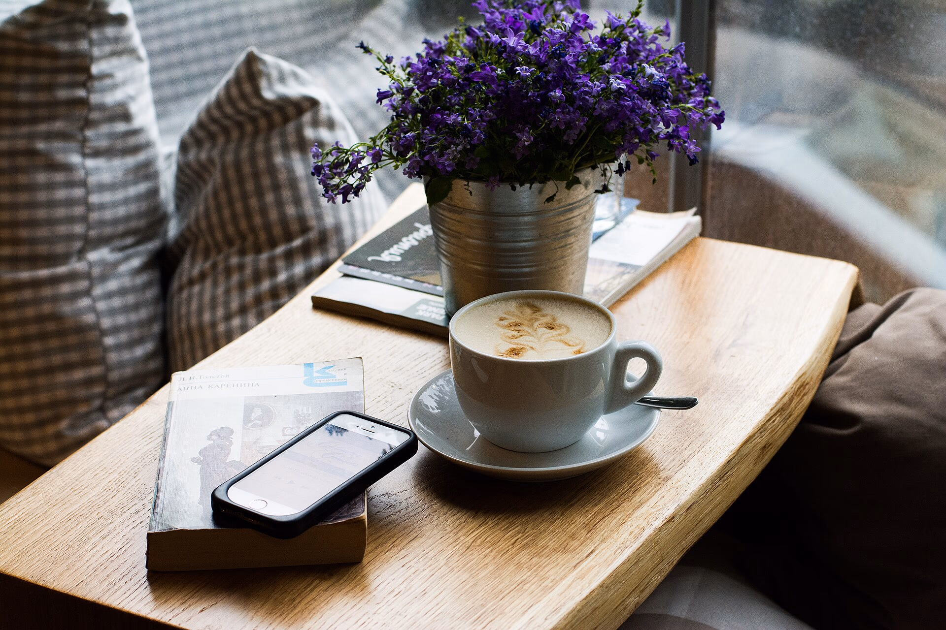 coffee, flowers and books on a table
