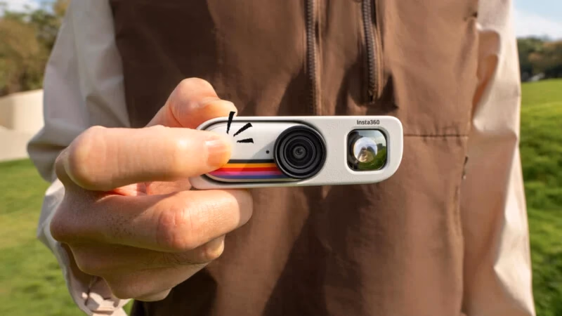 Image 4: A person holds an Insta360 action camera with a retro rainbow stripe design, outdoors on a sunny day, with grass and trees in the blurred background.